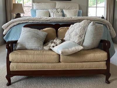 Vintage Wooden Frame Loveseat with Tan Upholstery and Cane Details