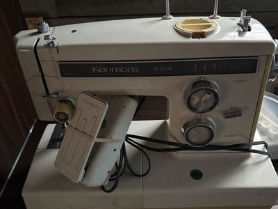 Kenmore 12 Stitch Vintage Sewing Machine with Foot Pedal and drop leaf sewing cabinet.