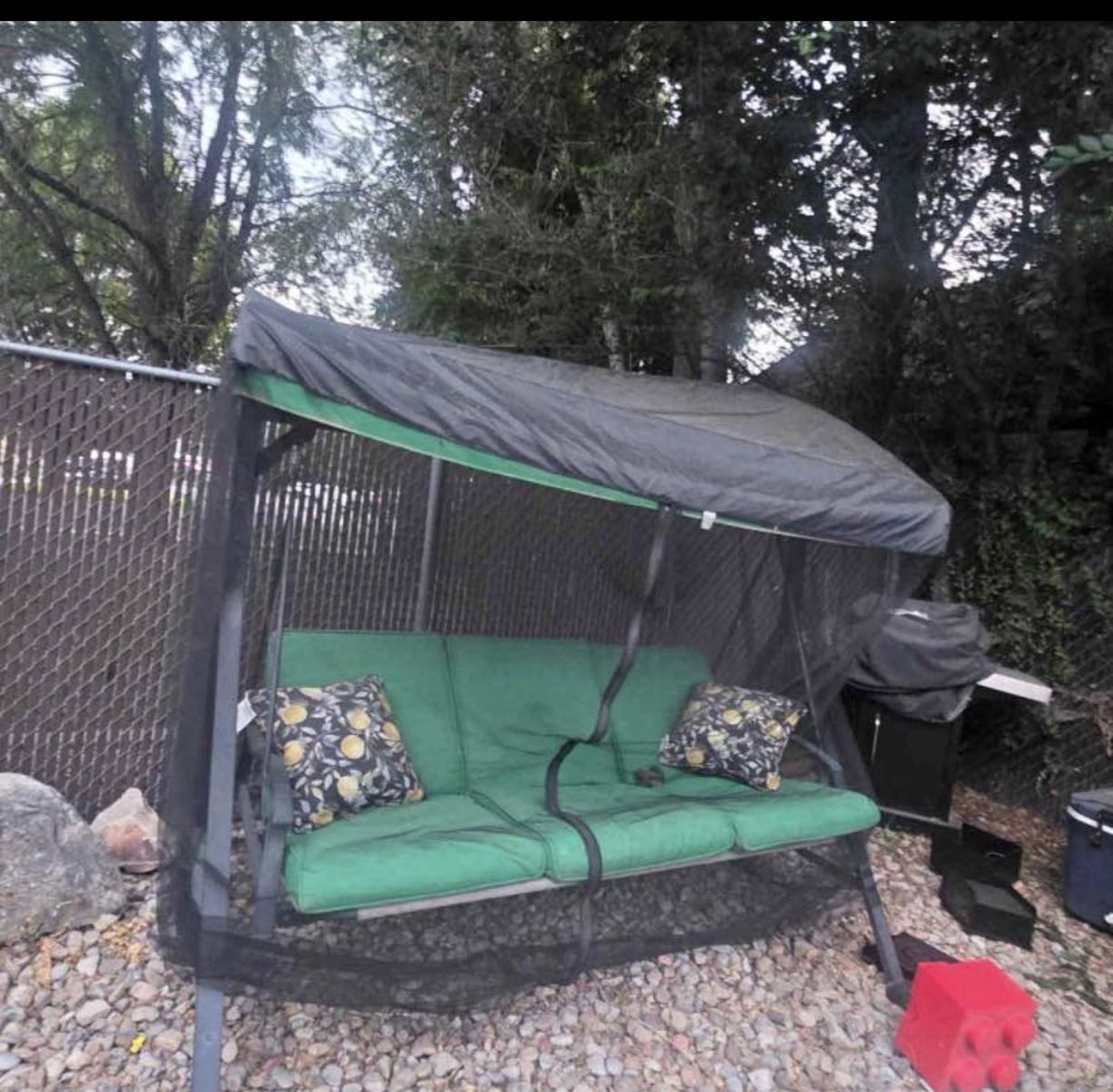 Outdoor Patio Swing Daybed with Green Cushions, Canopy, and Netting