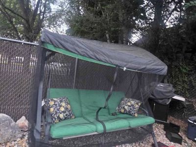 Outdoor Patio Swing Daybed with Green Cushions, Canopy, and Netting