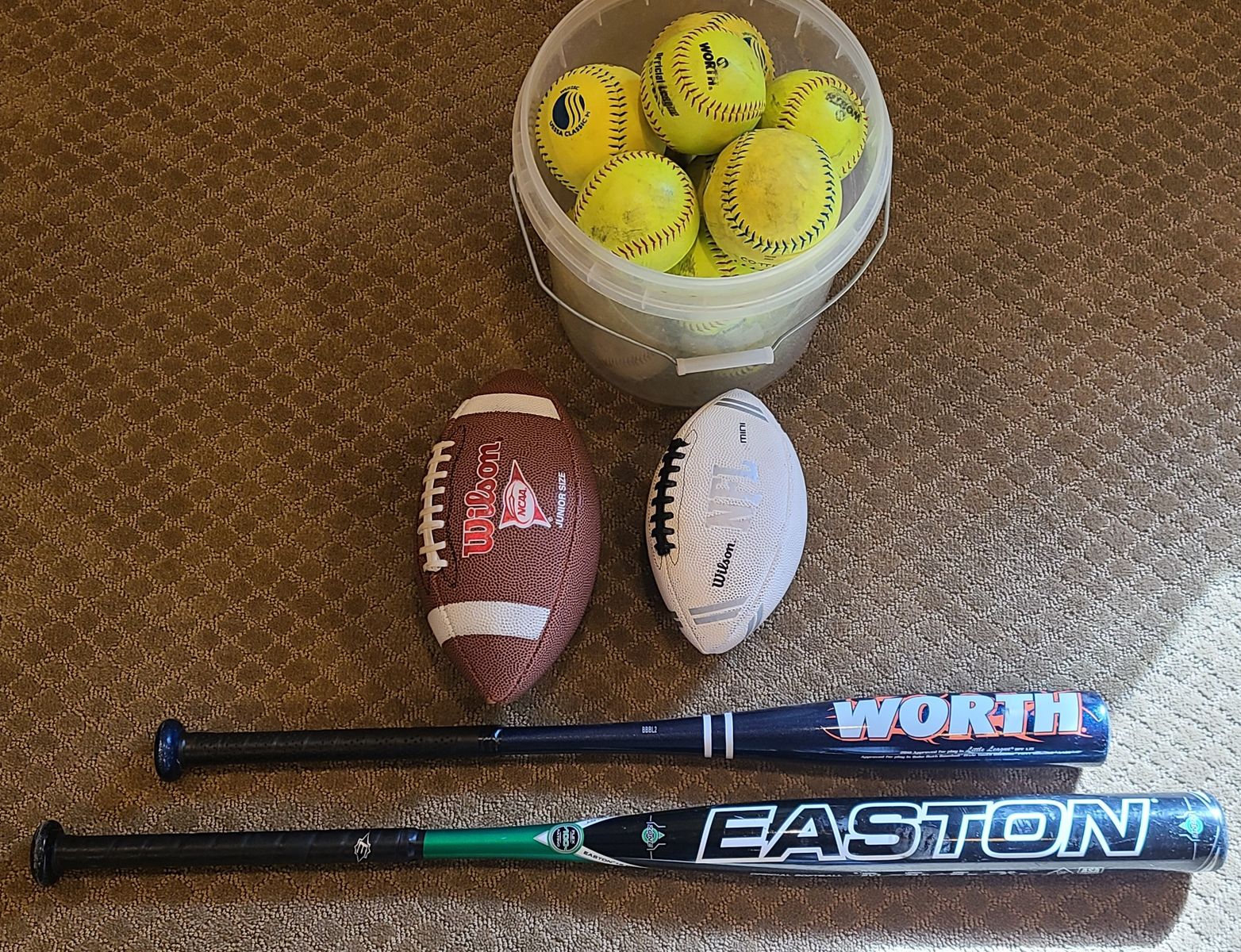 Sports stuff to include bats, softballs, and footballs