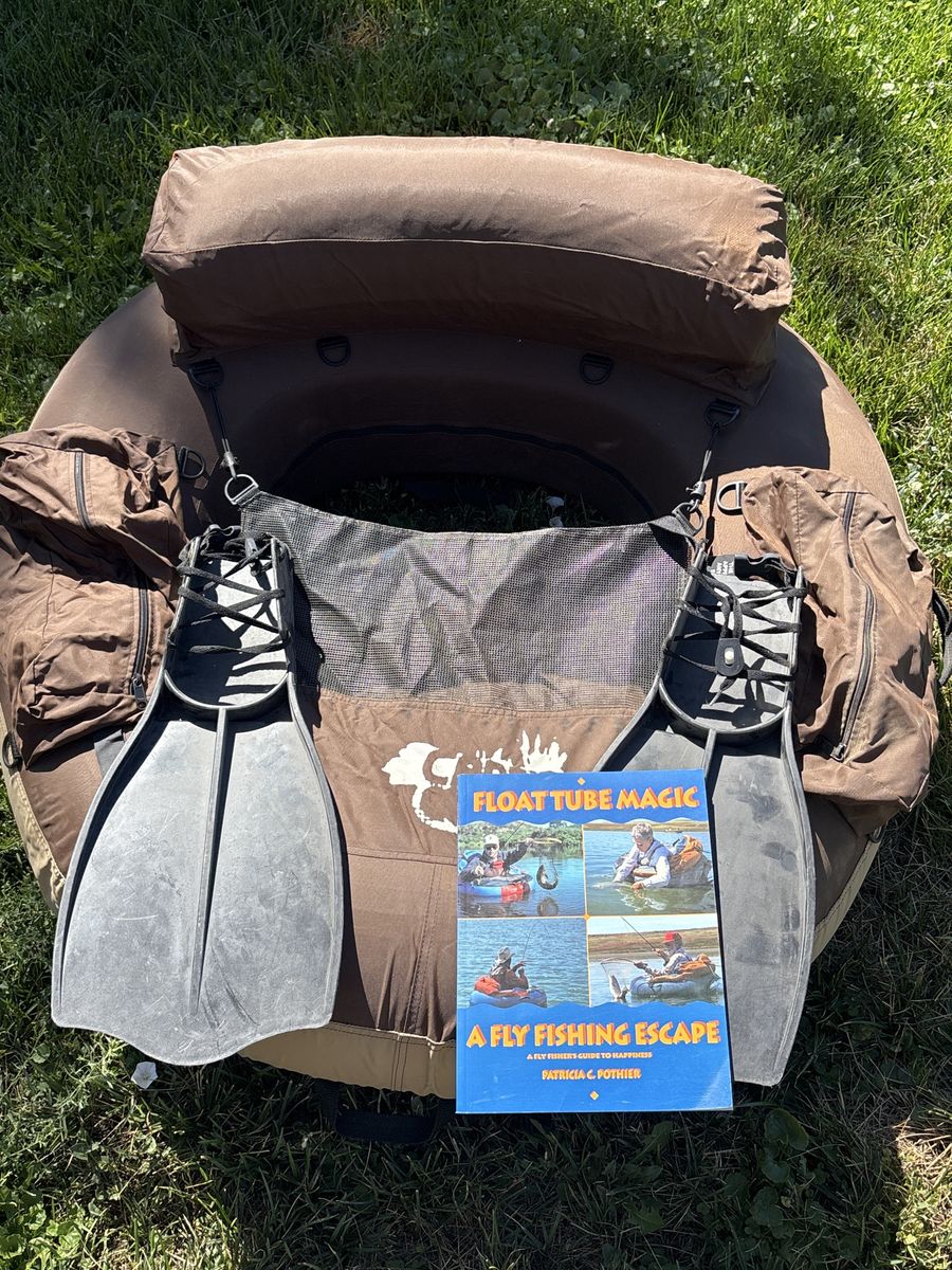 Float tube with flippers and book. 