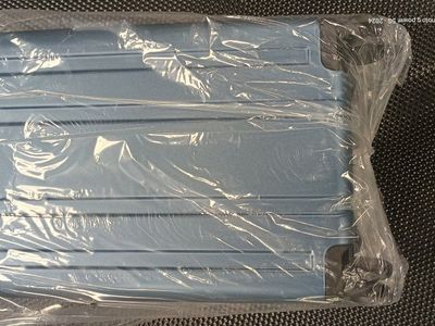 new in packaging blue 20inch hardshell suitcase