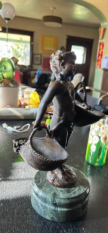 Solid Bronze Figure of a Girl Carrying Baskets. On marble base.