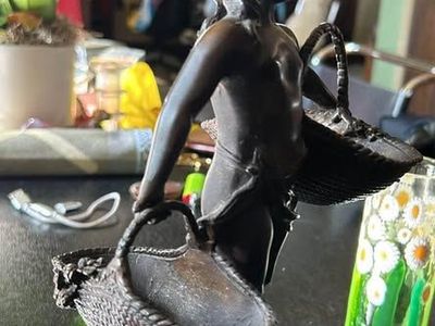 Solid Bronze Figure of a Girl Carrying Baskets. On marble base.