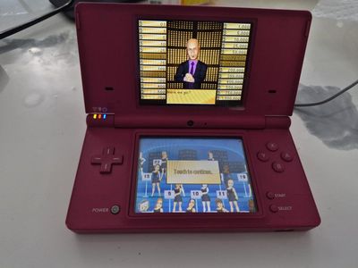 Nintendo DSi in hot pink,includes a proprietary charging adapter and 1 game