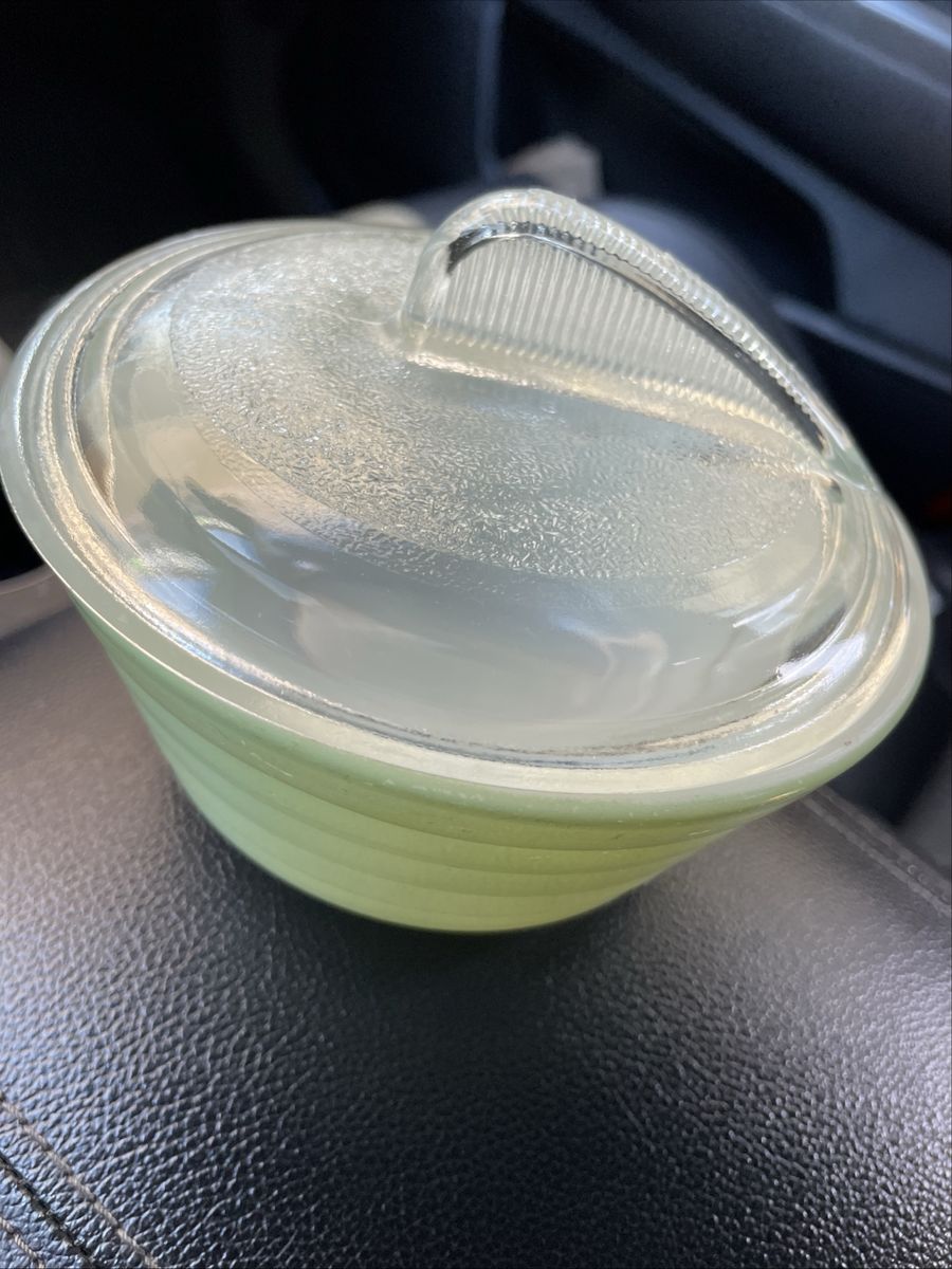 vintage green bowl appears to be a Jeannette Glass Jadeite Dripping Bowl, featuring a signature beehive-style ribbed design.