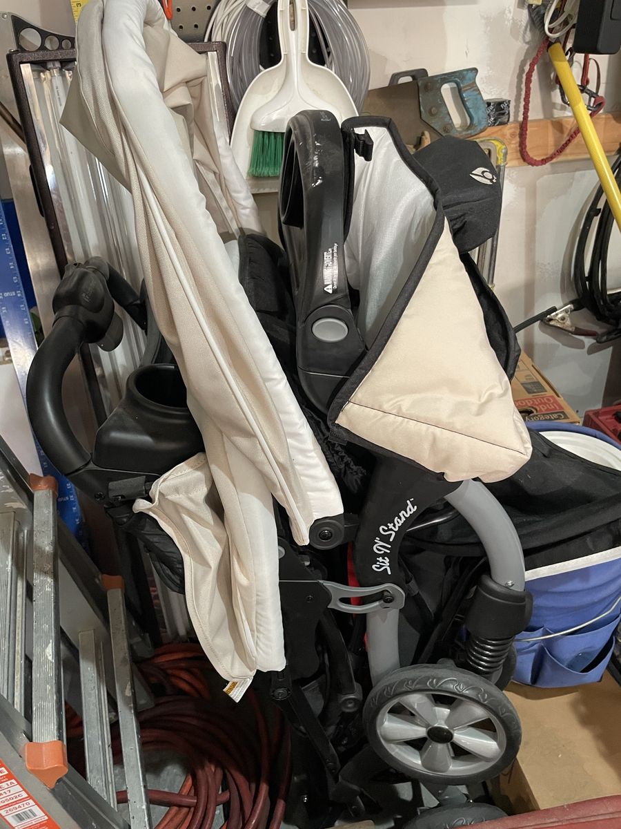 Sit and stand double stroller with car seats and bases