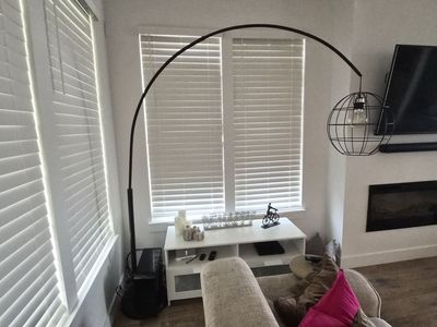 Industrial Style Arched Floor Lamp with Exposed Bulb & Spherical Metal Cage Shade