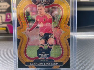 2025-26 Panini Select Leandro Trossard (06/10) Belgium Gold Mezzanine Prizm Soccer Card No. 161