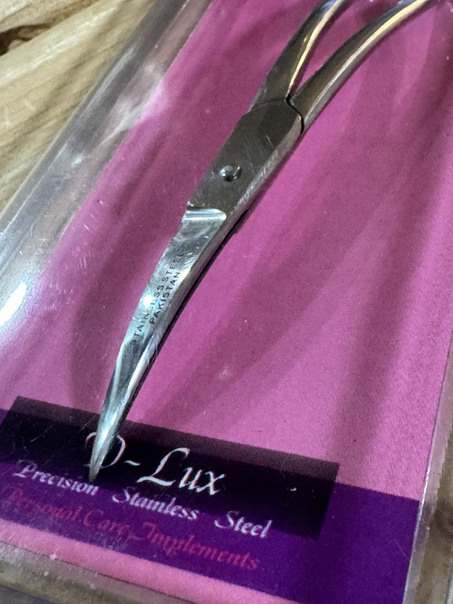 A pair of D-Lux Precision Stainless Steel Scissors, featuring a specialized curved design. $11
