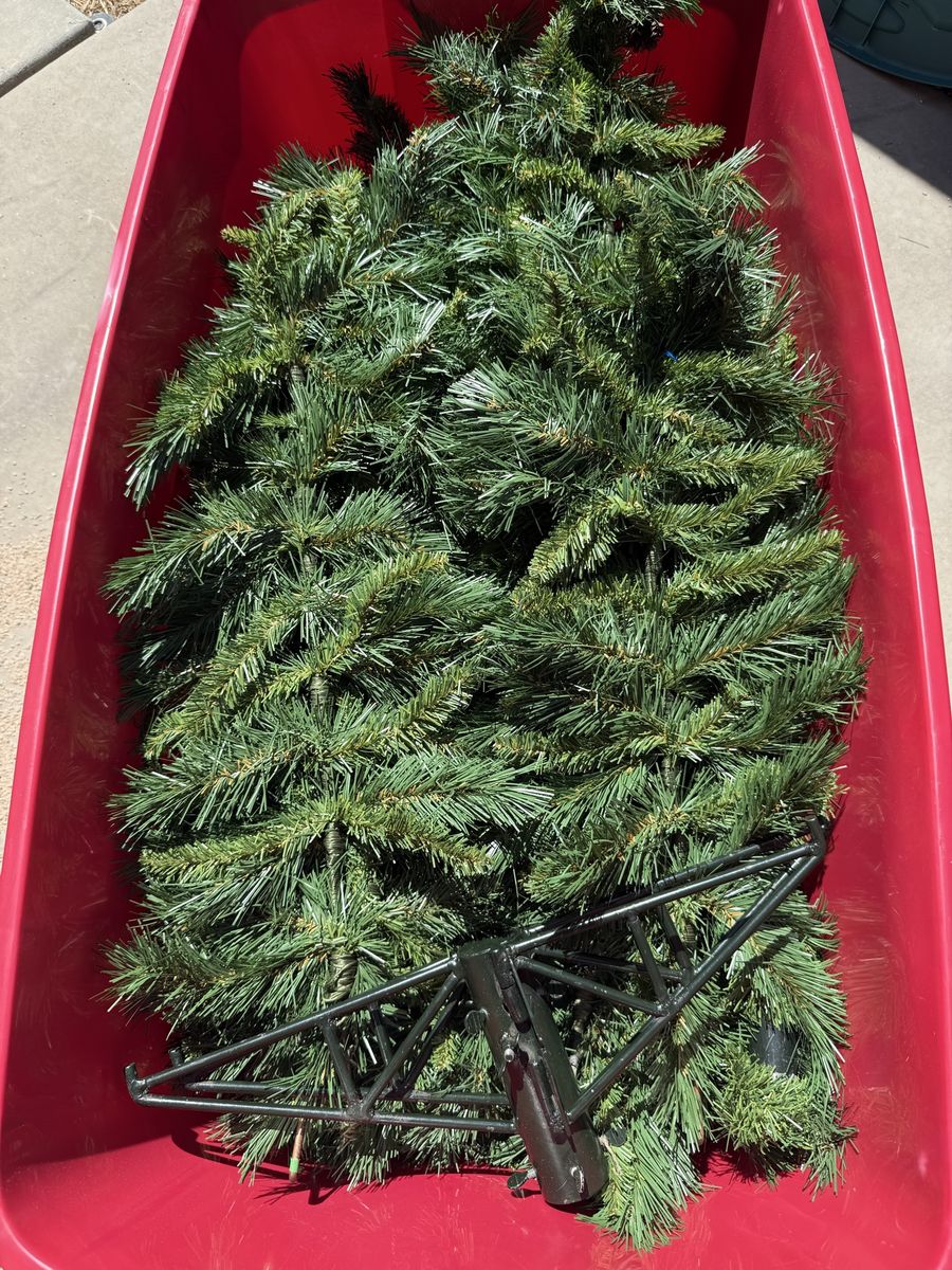 Used Artificial Christmas Tree - Green with Black Metal Stand 7 1/2 foot. Comes with the storage bucket too