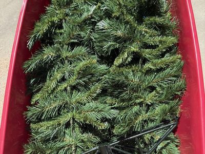 Used Artificial Christmas Tree - Green with Black Metal Stand 7 1/2 foot. Comes with the storage bucket too