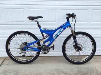 Two Specialized Mountain Bikes: a 2003 Epic Comp (Silver) and an Enduro FSR 2002 (Blue) Rarely Used