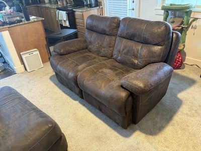 Brown reclining love seat