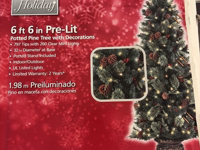 Home Accents Holiday 6.5 ft Pre-Lit Potted Pine Tree with Decorations