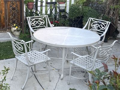 Thick metal patio set with round table (4) chairs.