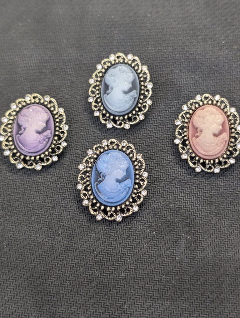set of 4 cameo brooches. asking $15 for all