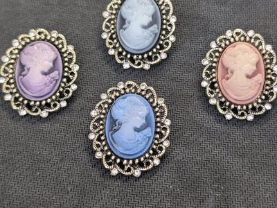 set of 4 cameo brooches. asking $15 for all