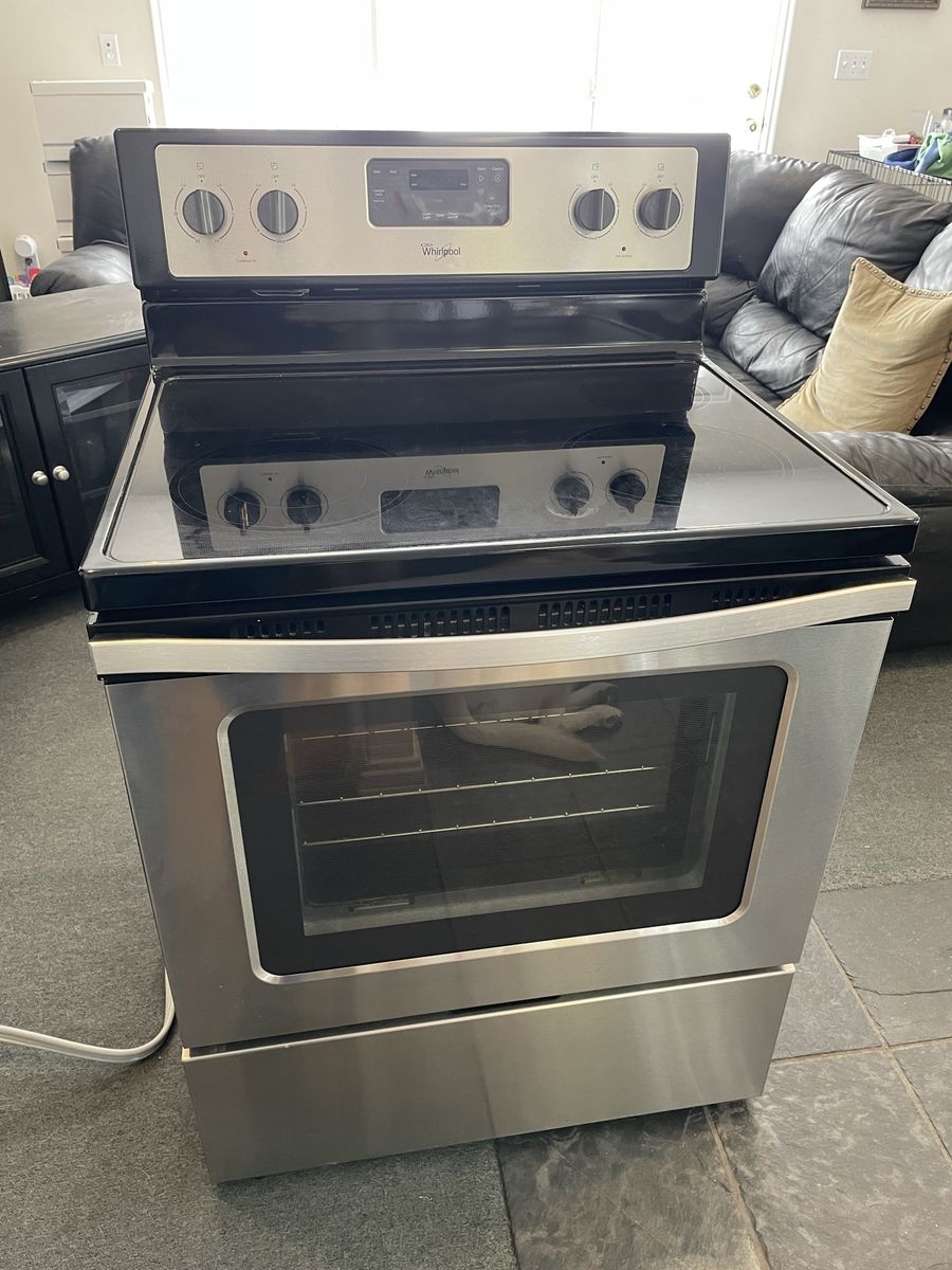 Whirlpool WFE320M0S0 electric range and GE over oven fan/light/hood.