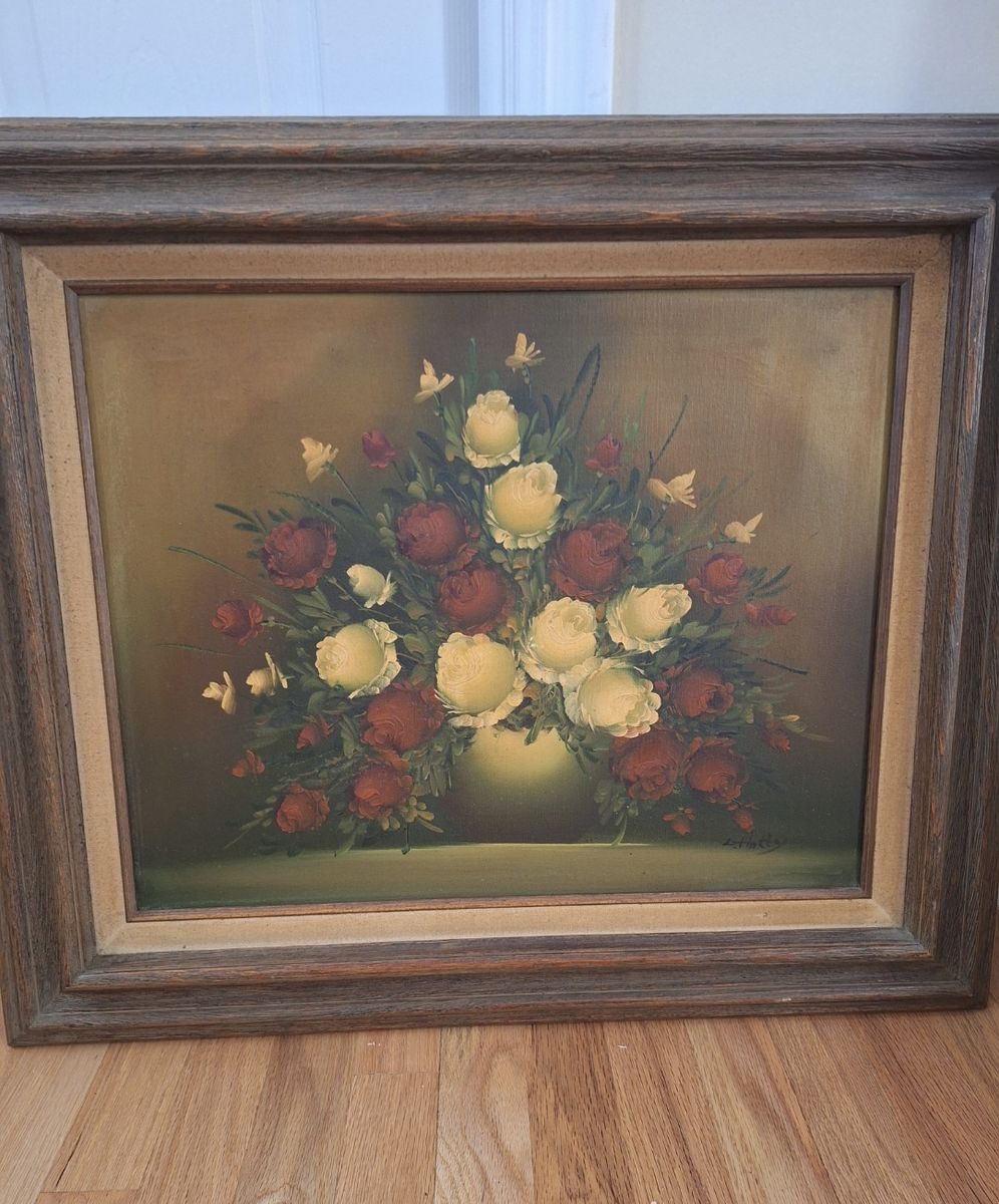 Vintage oil painting on canvas featuring red and white roses in a vase. 27" wide x 23" tall.
