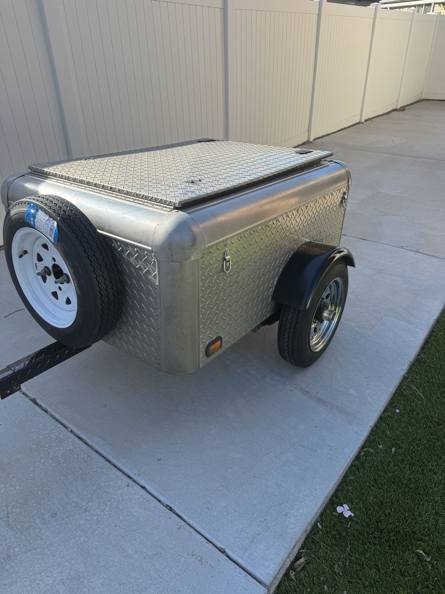 Cargo trailer can be towed behind car or motorcycle