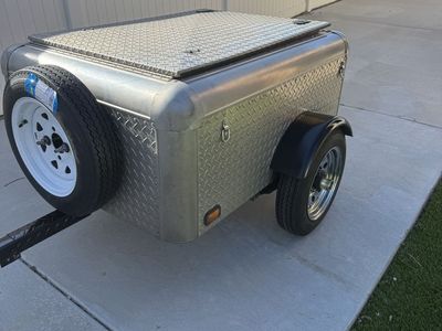 Cargo trailer can be towed behind car or motorcycle