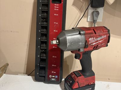 Milwaukee M18 FUEL 1/2" Impact Wrench with XC5.0 Battery and Husky 11-Piece Metric Socket Set