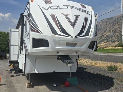 Dutchmen Voltage Fifth Wheel Toy Hauler Trailer with Rear Patio and Slide Outs