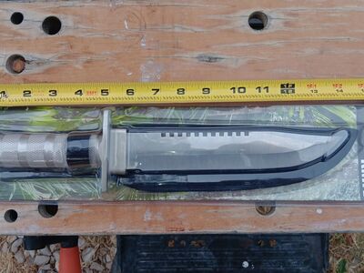 Survival knife with survival items and a compass in the rear compartment. $15