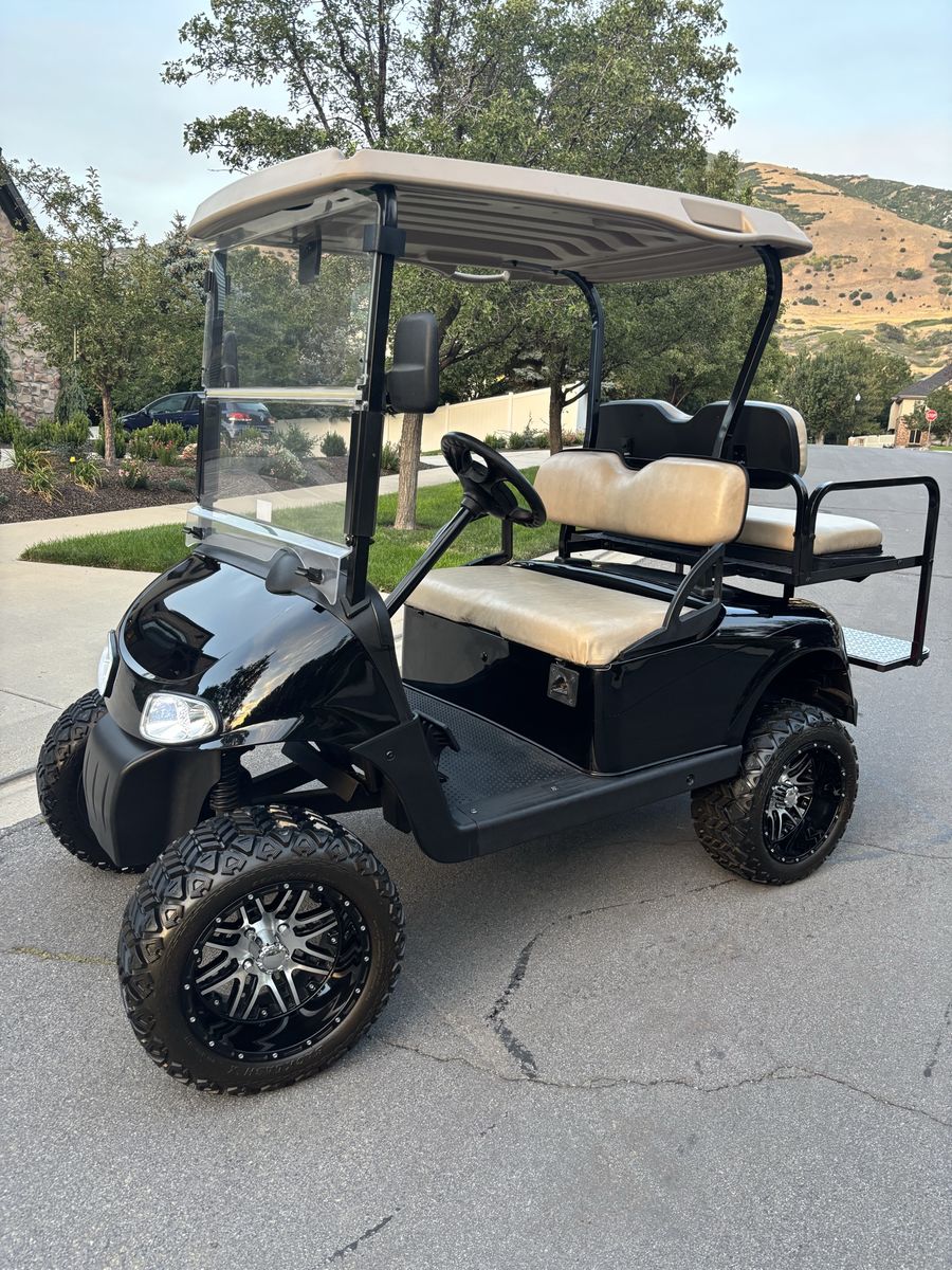 Custom Black Golf Cart with Lifted Wheels and Rear Seat