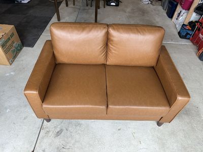 Brown faux leather loveseat