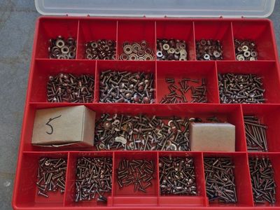 Assorted Stainless Steel Screws, Washers and Fasteners in Red Storage Organizer Box. Used on Aircraft Inspection Covers.