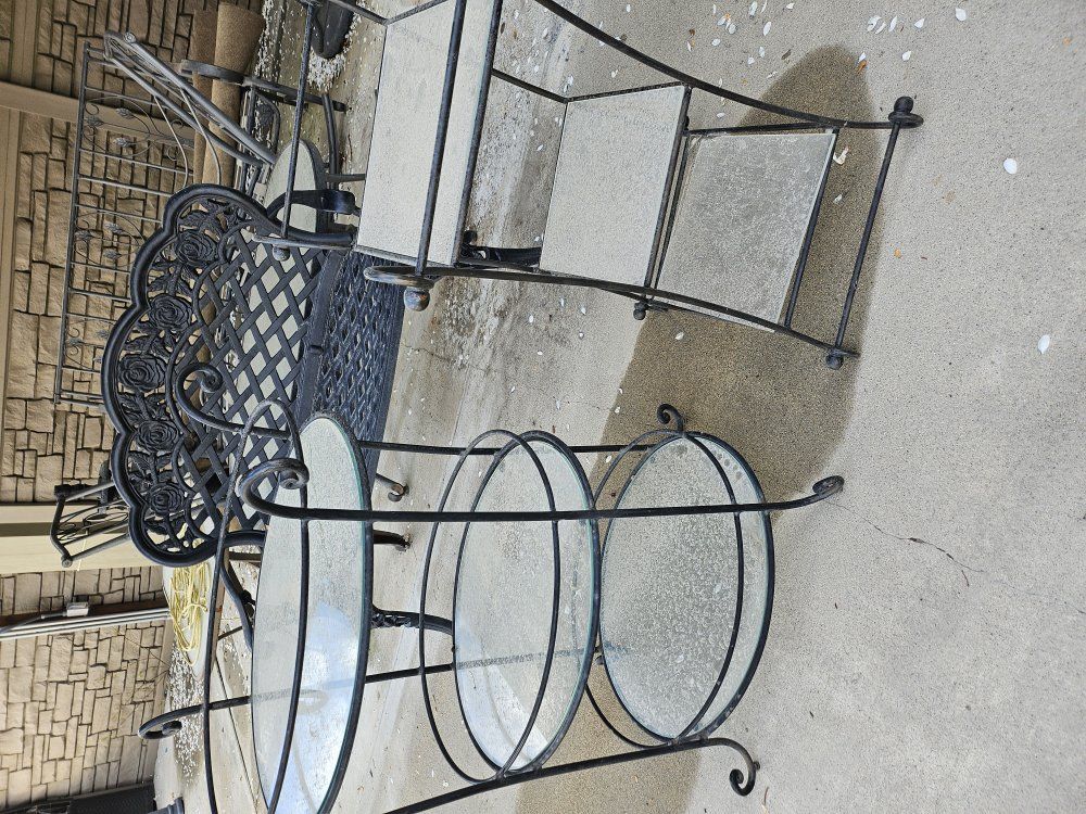 Two iron and glass outdoor tables