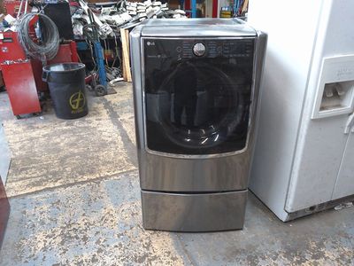 Whirlpool and LG front load electric dryers on pedestals