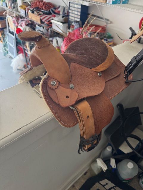 small Western saddle, most likely a youth saddle or a pony saddle