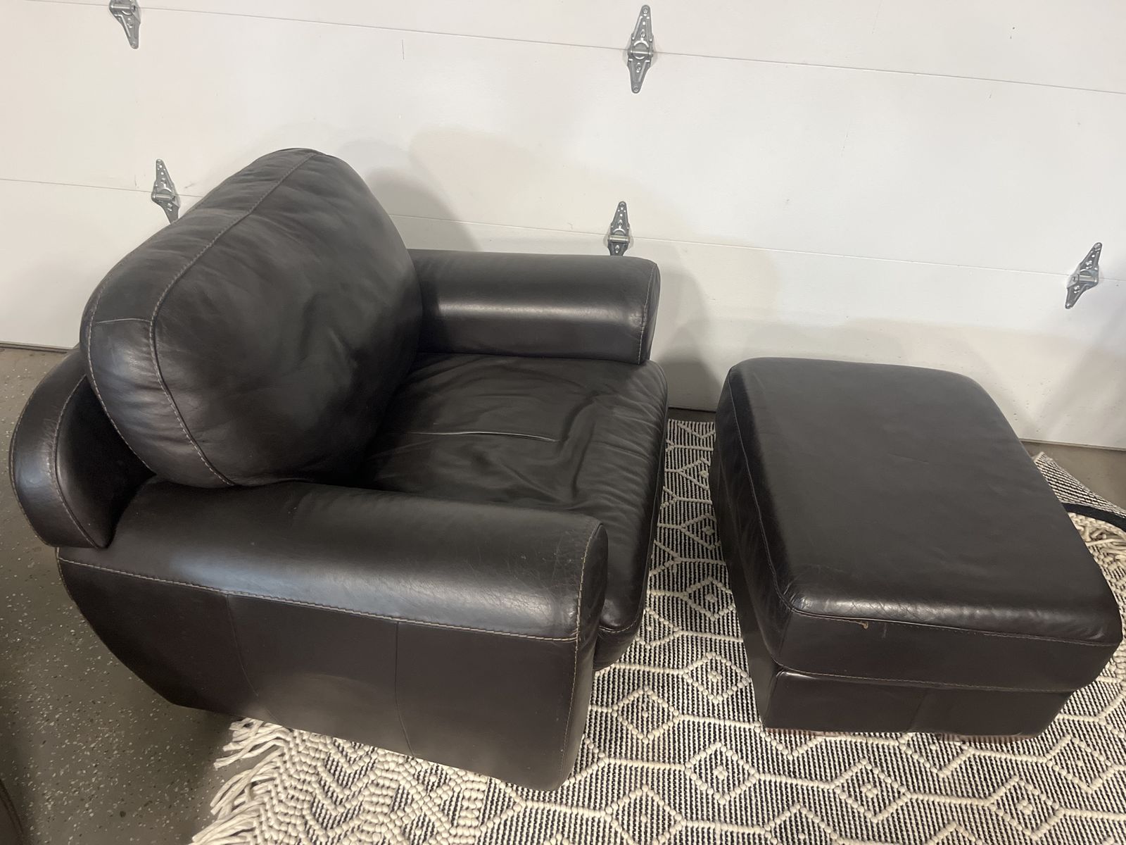 2 identical Black leather chairs and ottomans