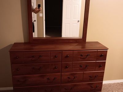 Bedroom dresser with a mirror and two nightstands.