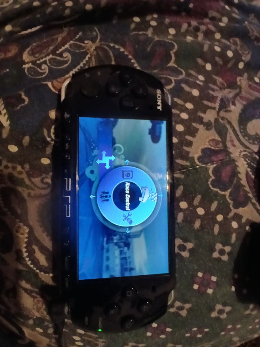 PSP 3000 console,  Black,  with 6 games in hard case,