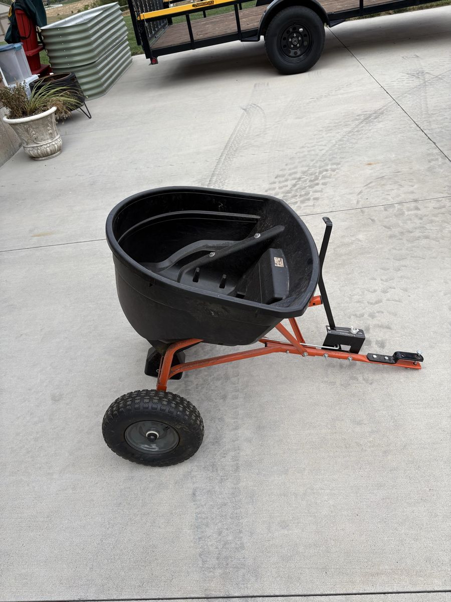 Agri-Fab Tow-Behind Broadcast Spreader with Orange Frame and Black Hopper