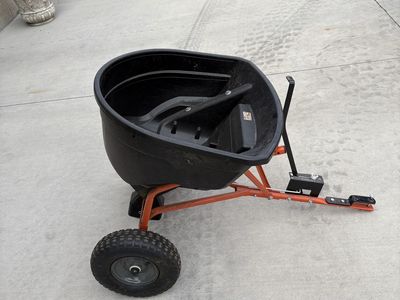 Agri-Fab Tow-Behind Broadcast Spreader with Orange Frame and Black Hopper