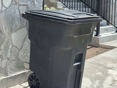 Toter 96-Gallon Black Outdoor Wheeled Trash Can with Attached Lid