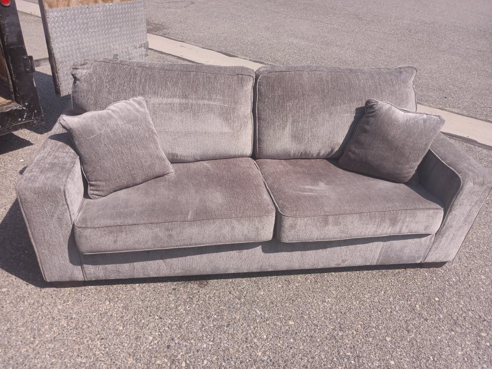 Used Grey Fabric Couch with Two Throw Pillows - Good Condition