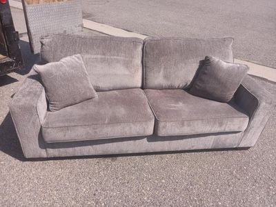 Used Grey Fabric Couch with Two Throw Pillows - Good Condition