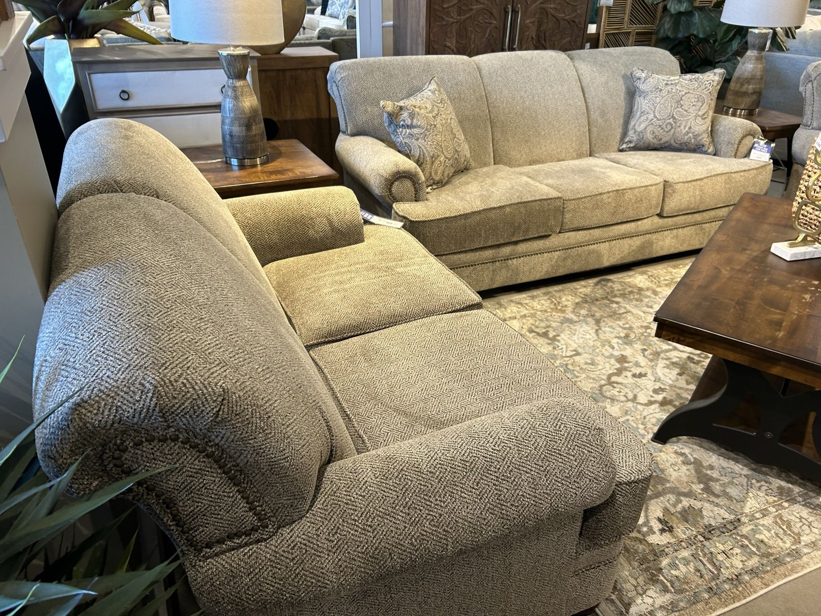 Stylish Tan Herringbone Sectional Sofa with Nailhead Trim and Decorative Pillows