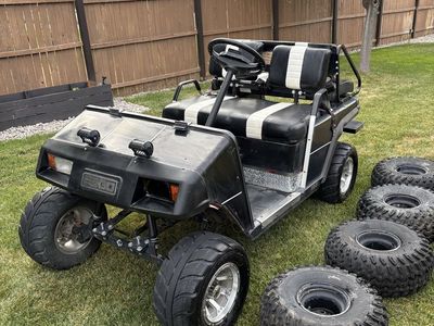 EZ Go Golf Cart - Black with White Stripes, Lifted with All-Terrain Tires, Includes Extra Set of atv Tires