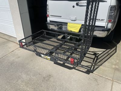 Hitch mounted wheelchair or scooter cargo carrier with ramp