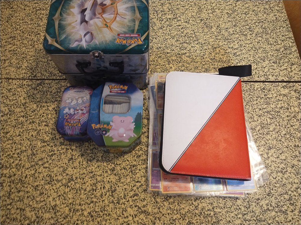Large Pokemon Trading Card Game Lot: 2 Tins, 3 Mini Tins, Binder, & Hundreds of Cards