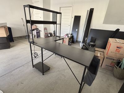 L-Shaped desk with power outlet and a hutch