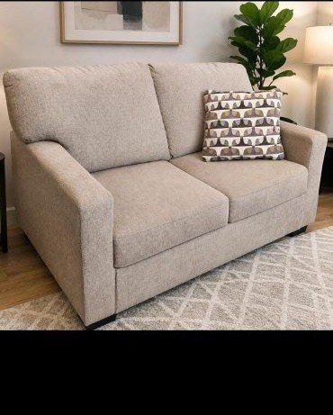 Cozy Brown Loveseat with Patterned Throw Pillow